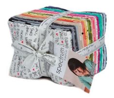 a stack of cloths that have different colors and designs on them, including one with an image of a woman's face