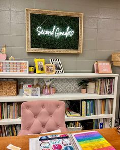 there is a pink chair in front of the bookshelf