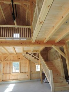 the inside of a large wooden building with stairs