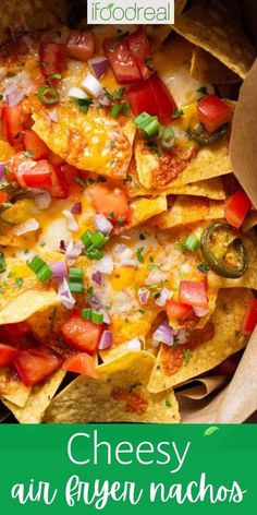 a bowl full of nachos with cheese and tomatoes on top, next to the words cheesy au fryen nachos