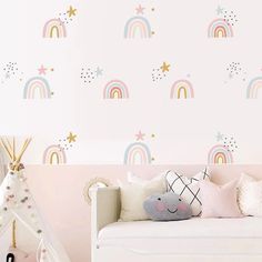 a child's bedroom with pink walls and rainbow wallpaper