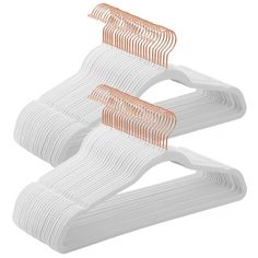 two white and orange plastic hangers on a white background, one with an orange stripe