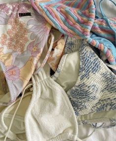 several different types of bras laid out on top of a white sheet with string