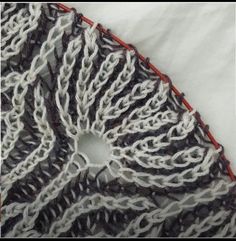 a close up of a knitted piece of cloth with white and black lines on it