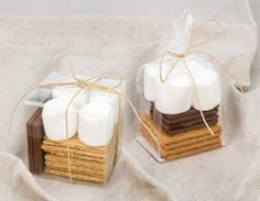 two small boxes with marshmallows tied in twine on top of each other