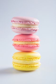 a stack of three macaroons sitting on top of each other in front of a white background