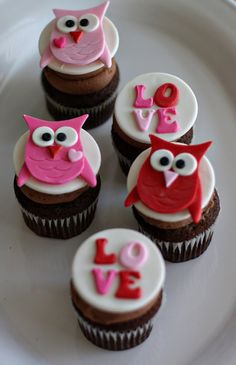 cupcakes decorated with pink and white frosting on a plate