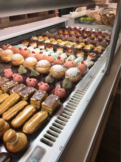 a display case filled with lots of different types of donuts and other pastries