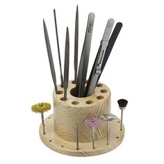 a wooden holder with knives and tools in it