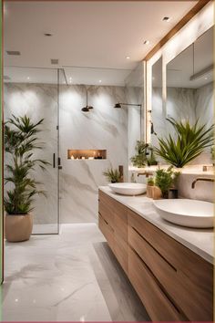 a bathroom with two sinks and a large mirror in it's center, surrounded by potted plants