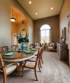 the dining room table is set with place settings for eight people, and there's no one sitting at it