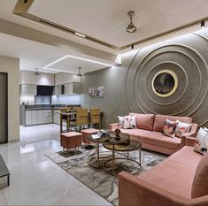 a living room filled with furniture next to a kitchen