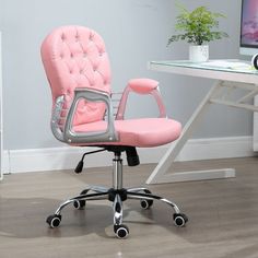 a pink office chair sitting in front of a computer desk with a monitor on it