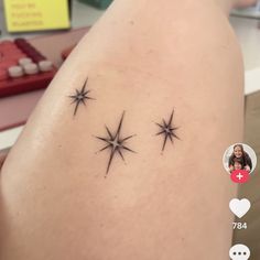 the back of a woman's thigh with three stars on it