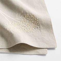 an embroidered design on the side of a linen material