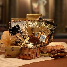 a basket filled with chocolates, cookies and other items sitting on a table next to a spoon