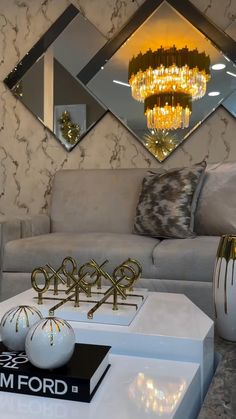 a living room with a couch, coffee table and mirror on the wall above it