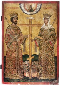 two men standing next to each other in front of a cross