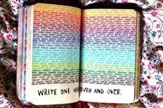 an open book sitting on top of a bed covered in colorful sheets and pillows, with the words write one word and over it