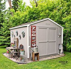 a small shed with a table and chairs in the yard