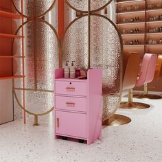 a pink cabinet sitting in the middle of a room next to shelves with bottles on them