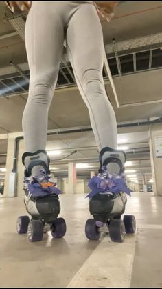 the legs of a person riding roller skates in a parking garage with purple ribbons on them