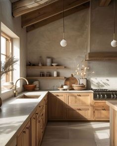 a kitchen with wooden cabinets and white counter tops next to an open window on the wall