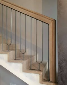 a set of stairs with metal railings and wood handrail