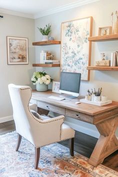 a desk with a computer on top of it in front of two shelves filled with books