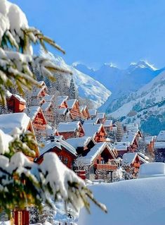 snow covered houses and mountains in the distance