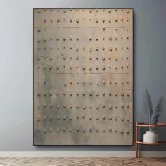 a large metal wall hanging over a wooden floor