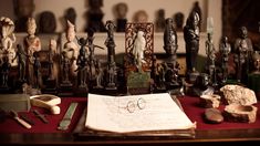 an open book sitting on top of a table covered in figurines and other items