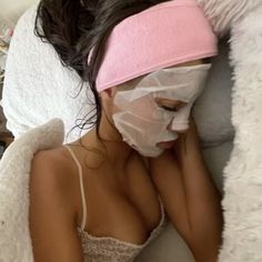 a woman with a bandage on her head laying in bed