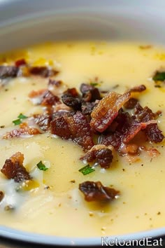 a bowl of soup with bacon and cheese in it