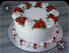 a white cake with red roses on it