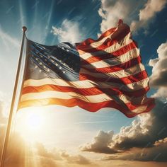 an american flag waving in the wind on a cloudy day with sun shining through clouds