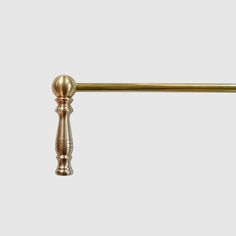 an antique brass pull handle on a white background