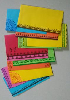 five different colored papers are stacked on top of each other, one is yellow and the other is blue