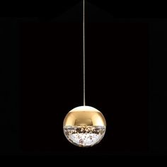 a round light fixture hanging from a black ceiling