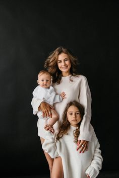 a mother and her two daughters posing for a family portrait