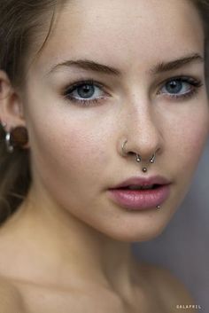 a young woman with piercings on her nose