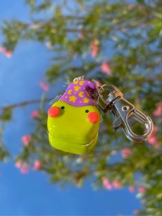 a key chain with a rubber duck wearing a party hat hanging from it's hook