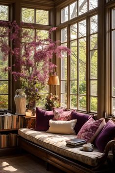 a living room filled with lots of windows and furniture next to a book shelf full of books