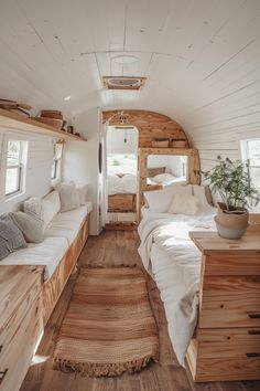 the interior of a tiny home with white walls and wood flooring, built into the ceiling