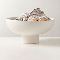 a white bowl filled with lots of different types of food in it's center