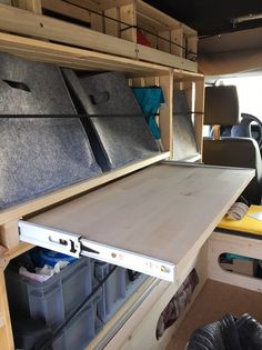 the inside of a camper with several storage bins