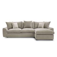 a large sectional couch with pillows on the top and bottom corner, in front of a white background