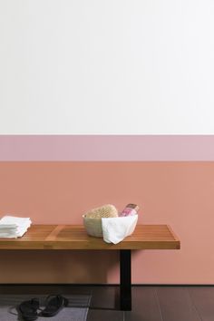 a wooden table topped with two white baskets