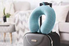 an inflatable travel pillow sitting on top of a suitcase