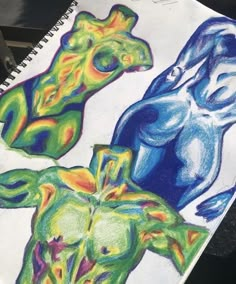 a drawing of three different colored figures on paper